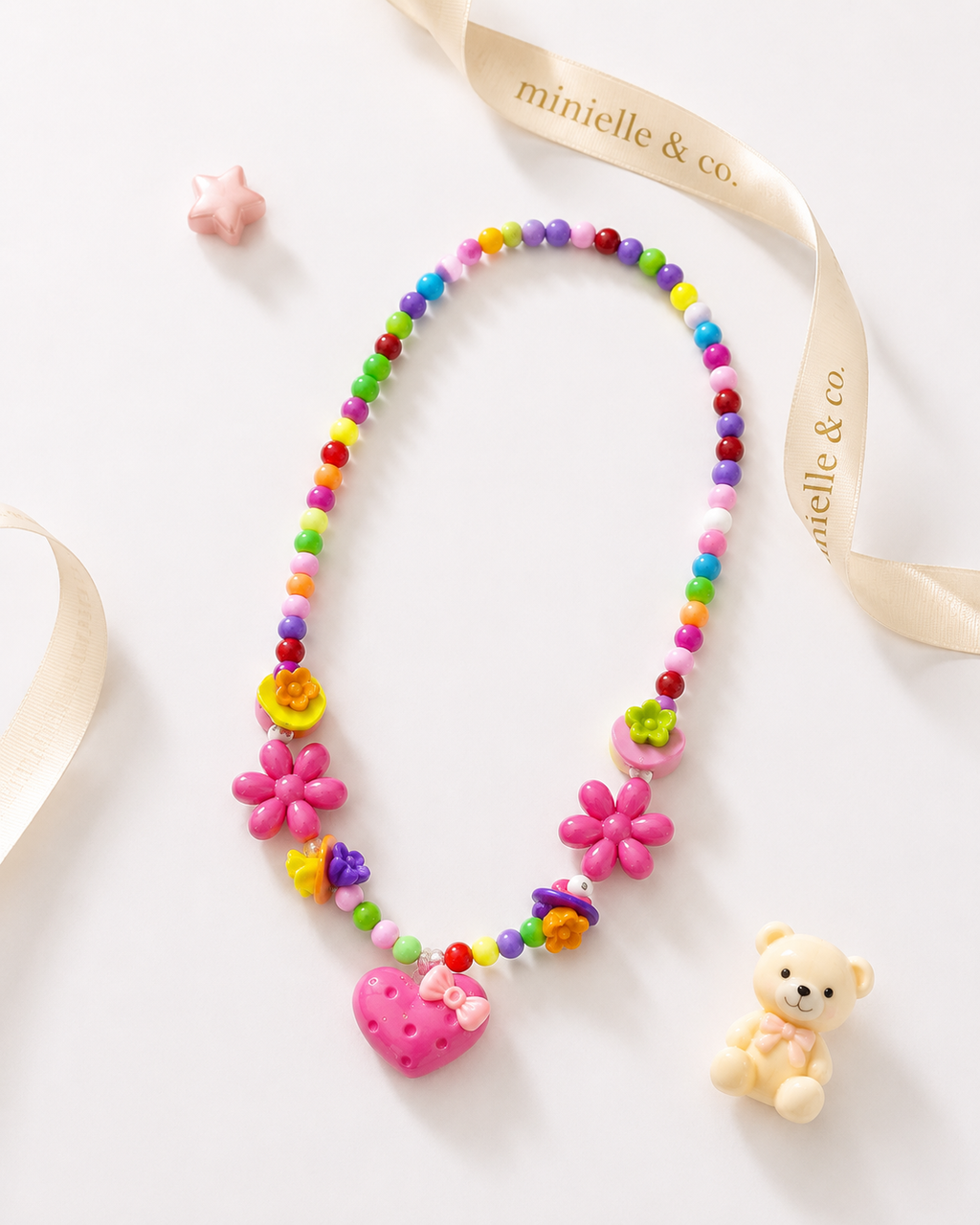 Colorful children's necklace with flowers and a heart on a white background